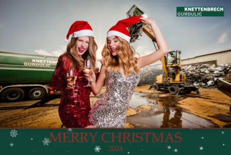 Zwei Frauen in Paillettenkleidern und Nikolausmützen posieren für ein Fotobox-Foto, das mit einem "Merry Christmas" Overlay und dem Firmenlogo von Knettenbrech-Gurdulic versehen ist.